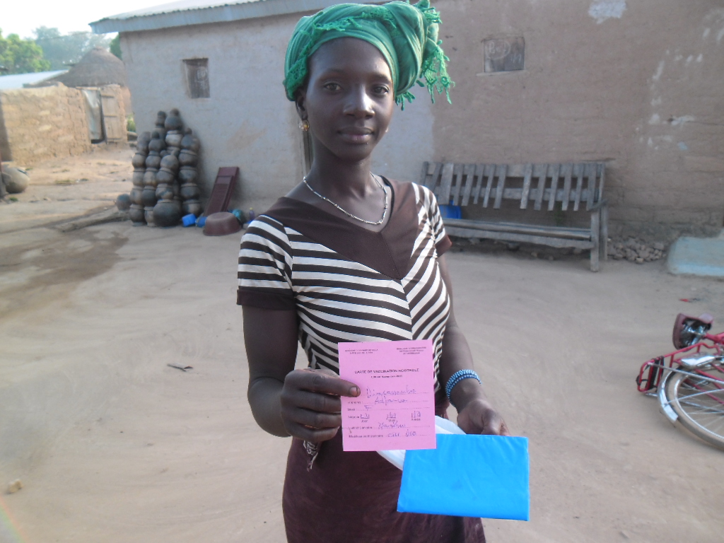 A health worker giving a young child a vaccination at a clinic