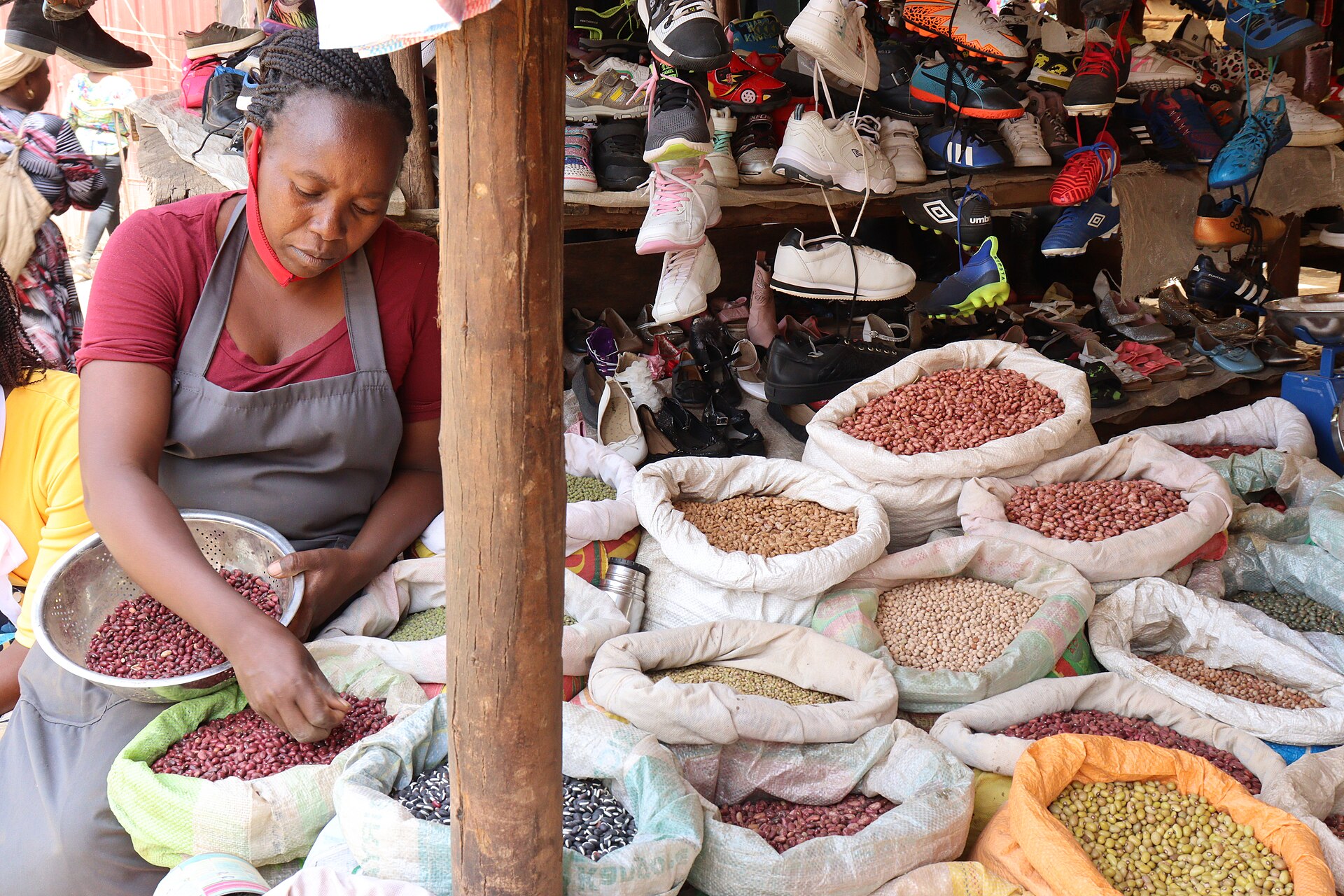 A trader using a mobile phone at an African market stall