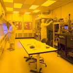 Semiconductor cleanroom engineers working on silicon wafer production lines